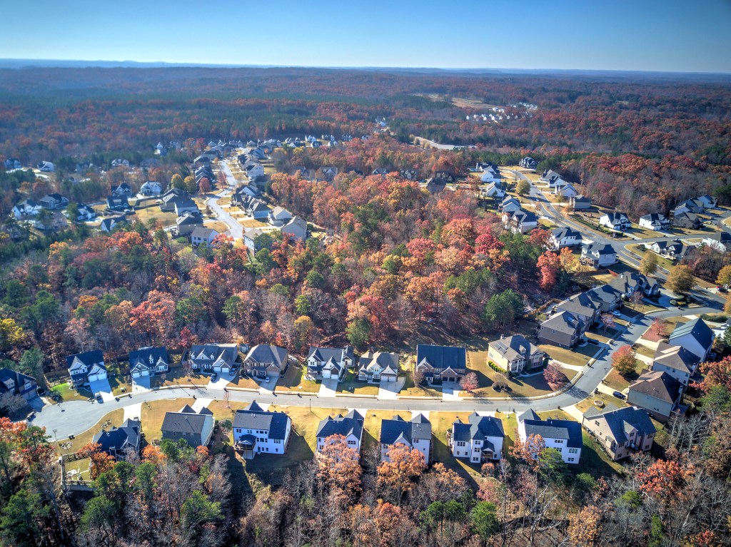 Aerial view of a Northwest Georgia residential community surrounded by wooded hills.